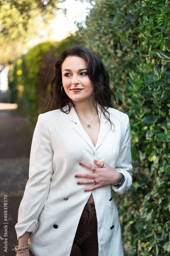 Young caucasian sexy business woman walking on a summer town street. Young caucasian sexy business woman walking on a summer town street.