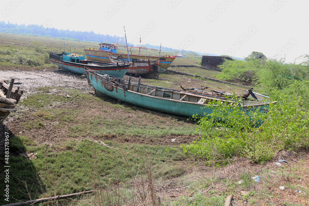 Wooden boats parked at dry land after fishing in India