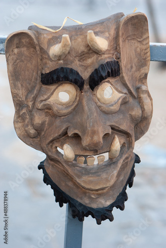 Traditional wooden devils mask on sale during Uzgavenes