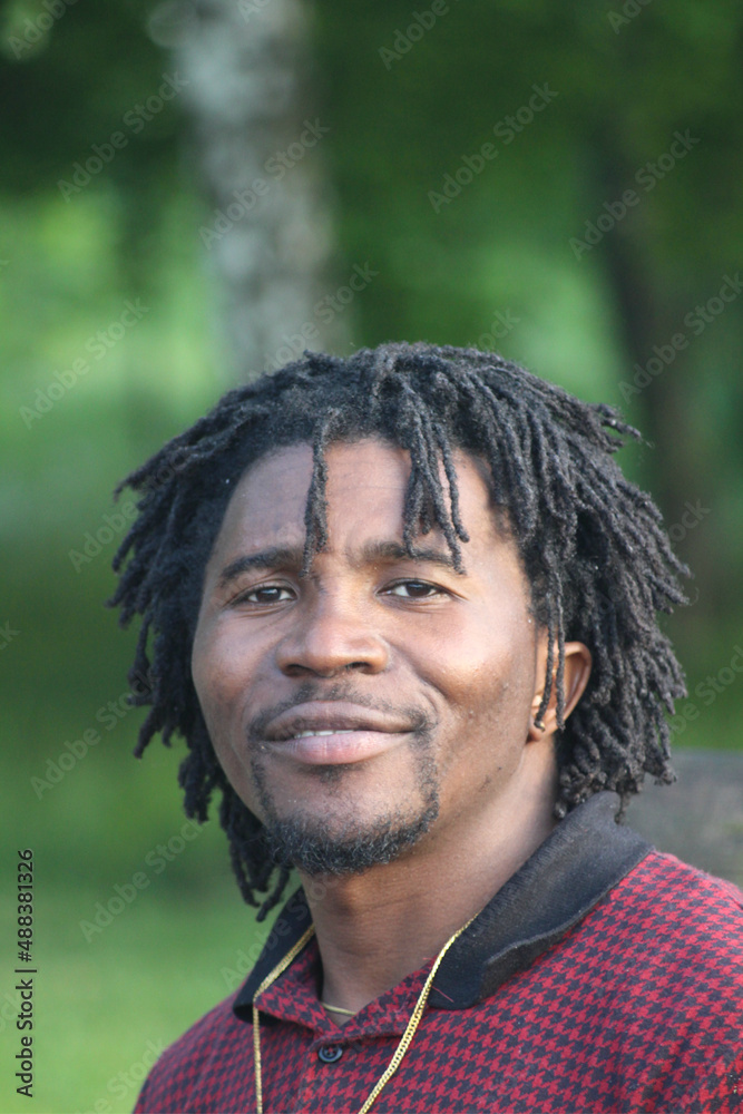 Portrait of a young man of African descent with a traditional hairstyle. Portrait of a young man of African descent with a traditional hairstyle.