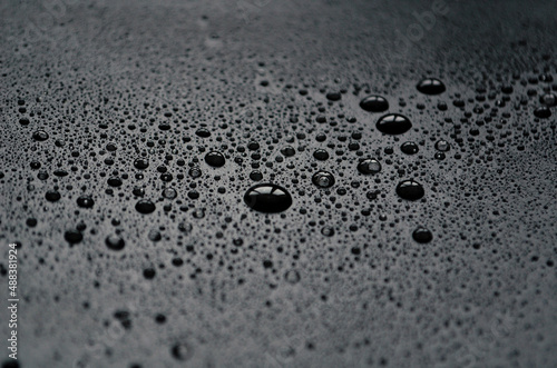 Canvas Drops of water on a dark matte surface close up, water blots, design concept fro