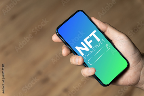 NFT marketplace - hand holding a phone