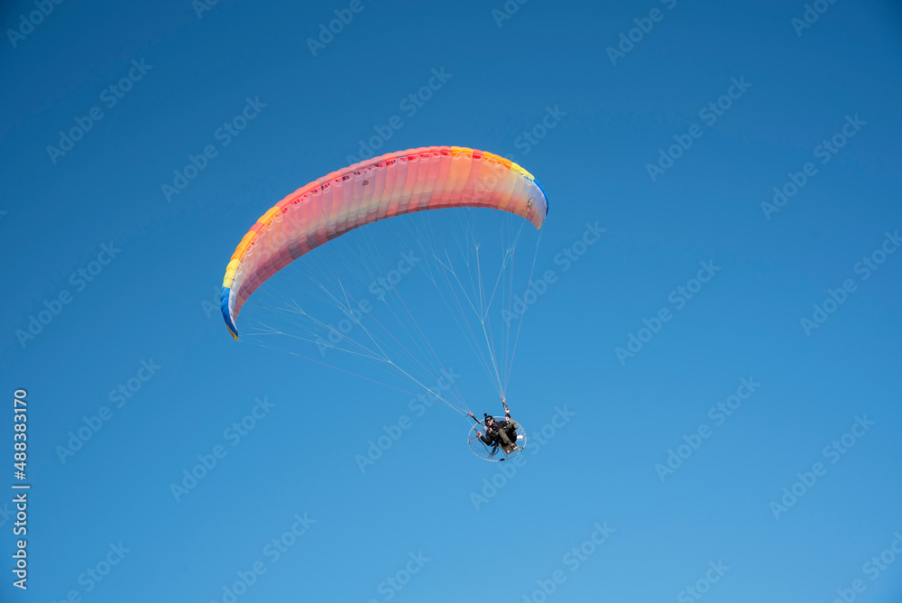 Motorized paragliders flying over the coast Motorized paragliders flying over the coast