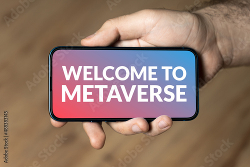 Welcome To Metaverse - hand holding a phone