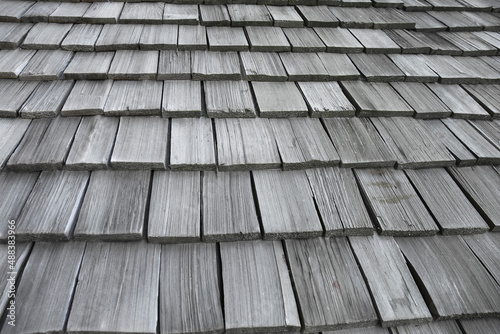Принти на полотні Wooden roofs are lined up for sun and background rain.