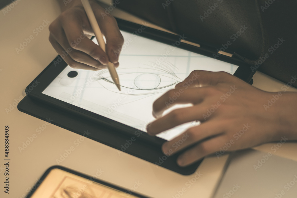 Teenager drawing with tablet and virtual pen. Millennial student doing