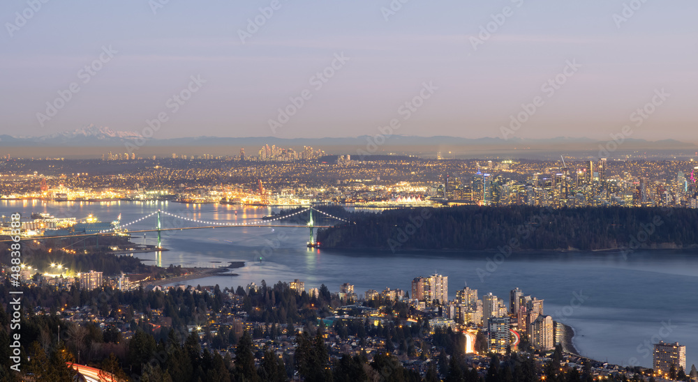 Panoramic View of Downtown Vancouver Cityscape, Stanley Park, Lions Gate Bridge and Burrard Inlet. Modern City on Pacific Ocean West Coast. Winter Sunset. British Columbia, Canada.