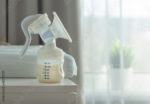 manual breast pump mith womens milk on a clother press