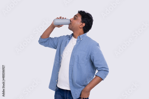 Indian Man Drinking Beer from Tin Can. Indian Man with Drink in Hands Isolated