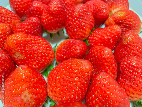 Closeup of fresh vivid red strawberry, fruit for healthy eating and diet
