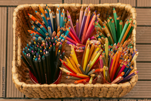 Color pencils in straw basket