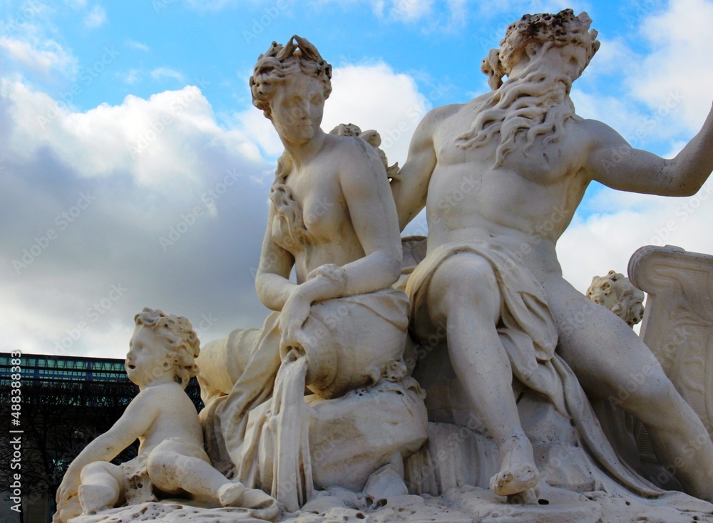 Sculpture of ancient antique Poseidon fountain in central Paris park.