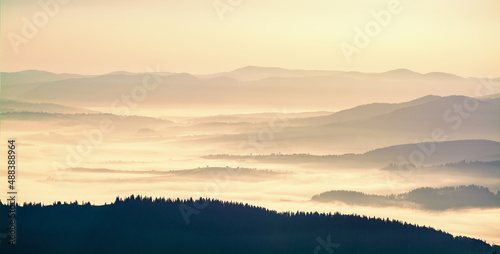 Beautiful sunrise in the Carpathians. Hills lines during sunrise. Beautiful natural landscape. Vibrant photo. Panoramic view.