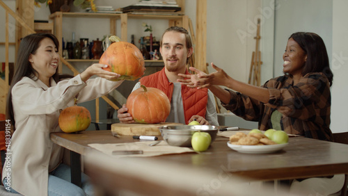 Young ladies exchange their pumpkins and start to draw it