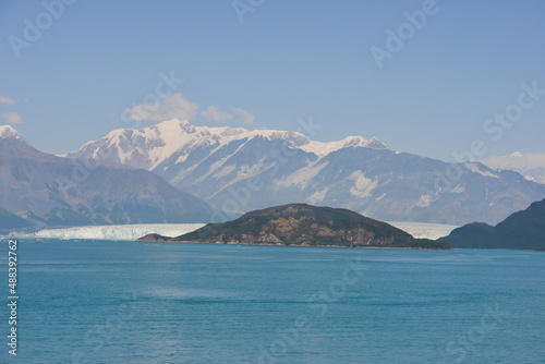 Landscape view of glacier and snow capped mountains in Alaska on a summers day, the beauty of nature threatened at moment by global warming and climate change.