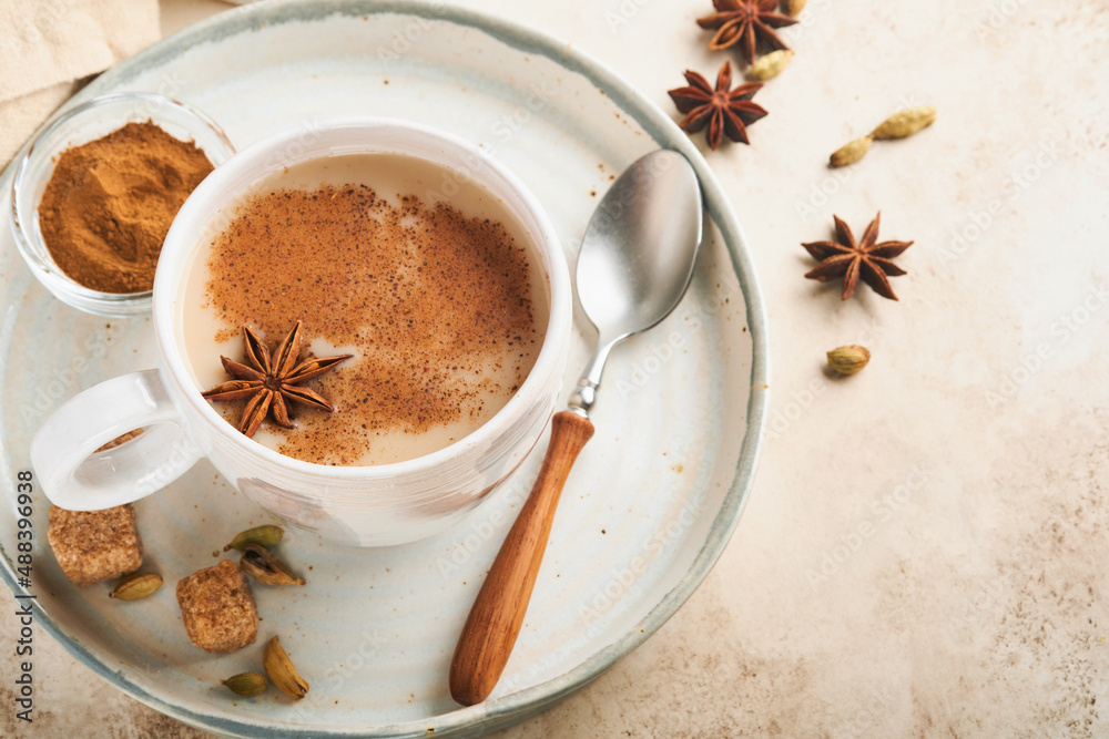 Masala tea. Masala chai spiced tea with milk and spices on light warm beige background. Traditional indian drink. Copy space. Selective focus. Masala tea. Masala chai spiced tea with milk and spices on light warm beige background. Traditional indian drink. Copy space. Selective focus.