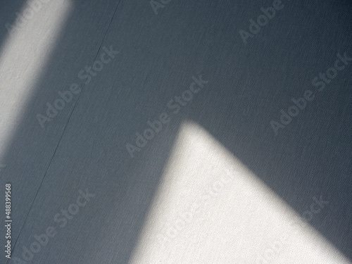 Close-up of a triangle of light on a gray wall. Abstraction  figure  wall  shadow  light