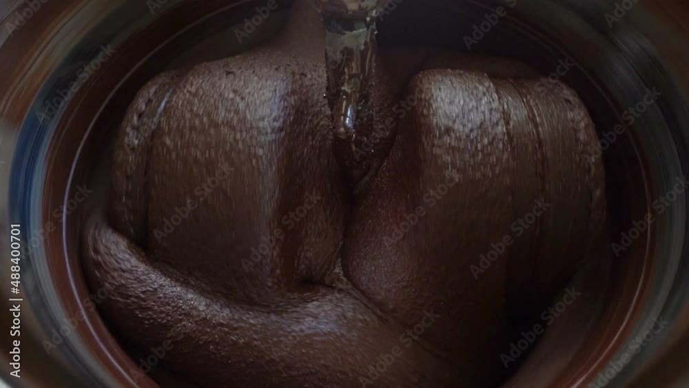 Macro Shot Of Cacao Beans Being Processed In A Conching Machine.