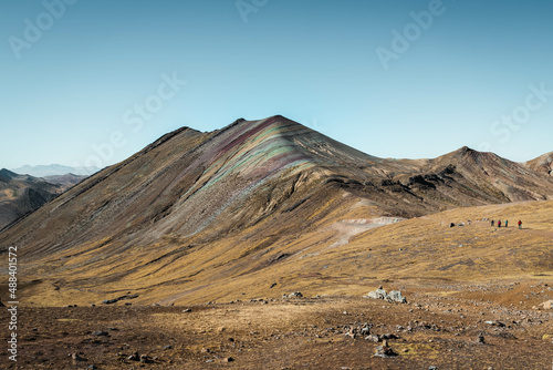 Colourful Rainbow Mountains in Palccoyo (alternative to Vinicunca) with red, yellow, green, orange and blue tones and snow-covered mountain peaks outside of Cusco (Peru, South America)