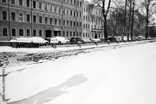 View of Griboyedov Canal embankment in winter, St. Petersburg, Russia. Black and white photo.