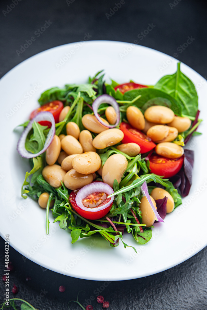 salad white beans, tomato, leaves lettuce mix petals fresh portion healthy meal food diet snack on the table copy space food background keto or paleo diet veggie vegan or vegetarian food no meat
