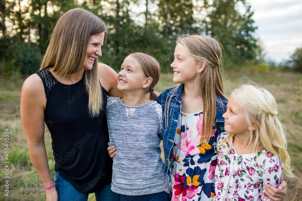 Mother and beautiful daughters smile, laugh together. Mother and beautiful daughters smile, laugh together.