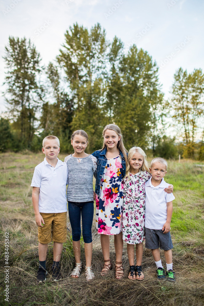 Outdoor portrait of five siblings, two boys, three girls. Outdoor portrait of five siblings, two boys, three girls.