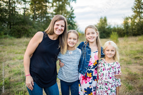 Outdoor portrait of mother and her three beautiful daughters.