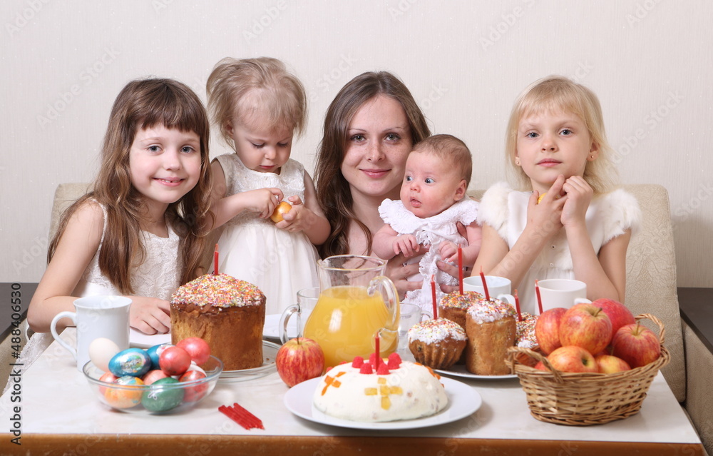 Family with Easter cakes at the table. Family with Easter cakes at the table.