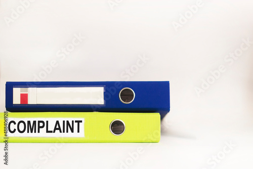 complaint words on a label with a folder for documents on a white background