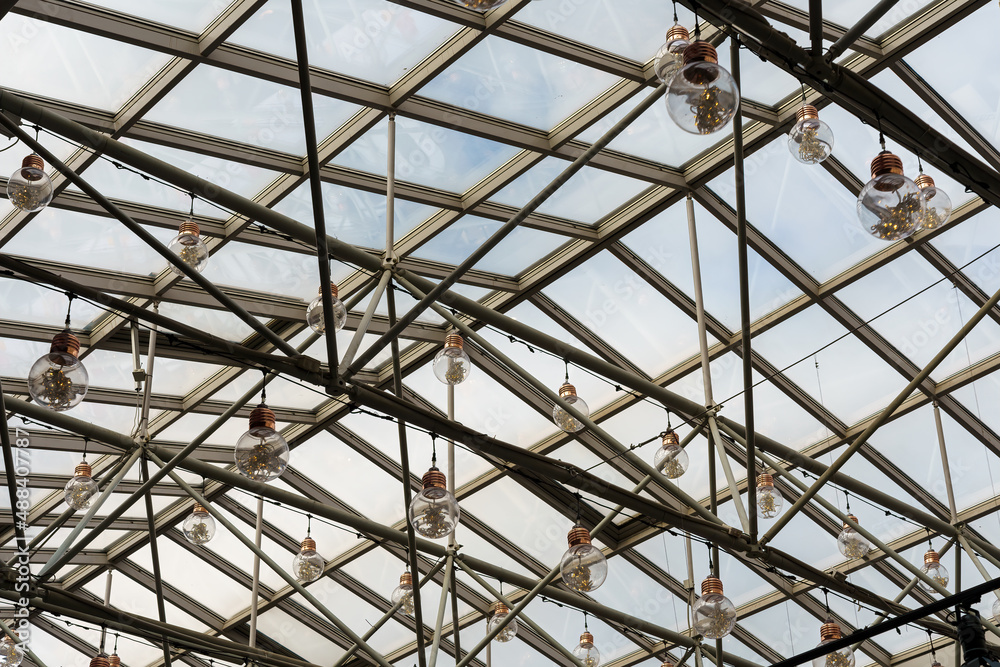 Glass roof and pendant lamps in form of large light bulbs.