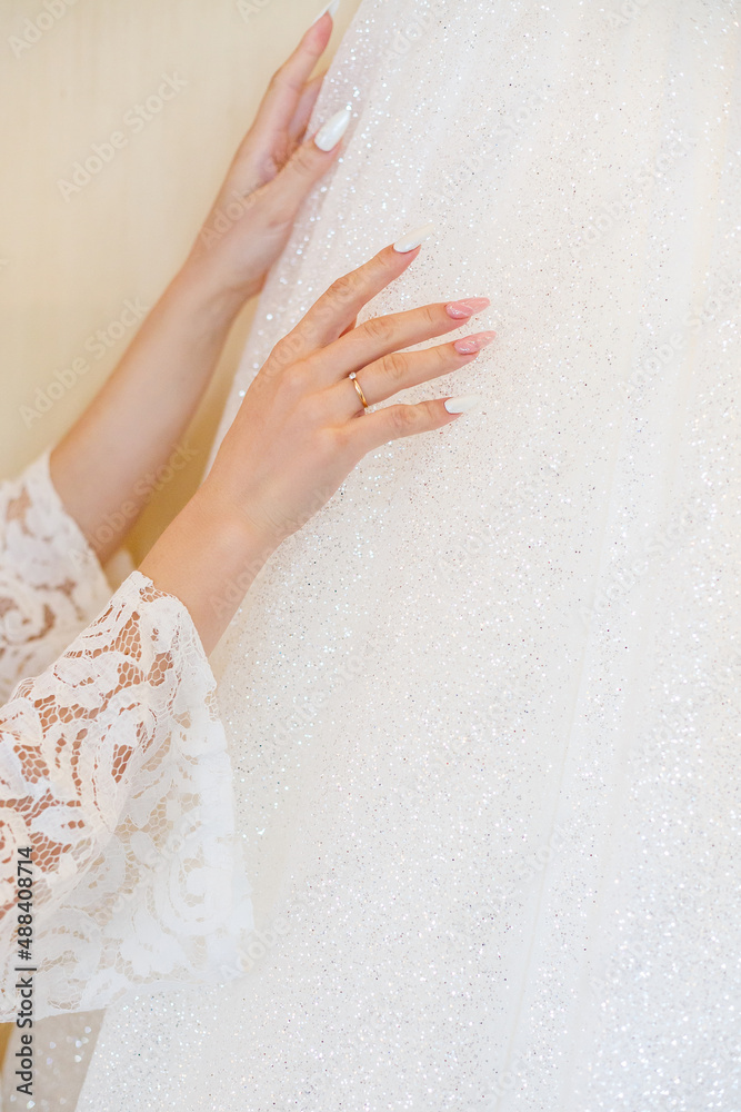 Beautiful young girl bride on a wedding day. White wedding dress. Modern dressy clothes for women