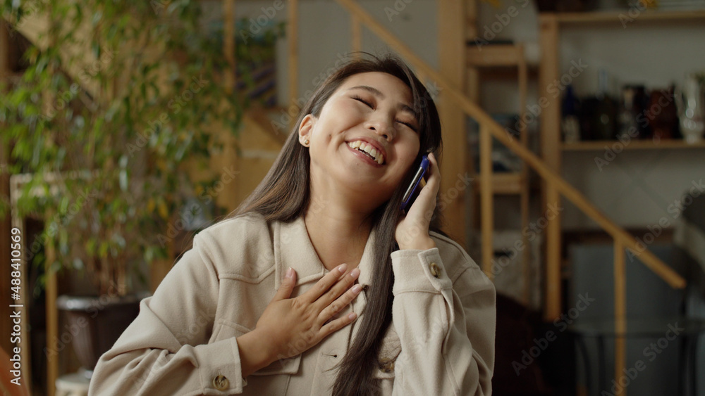A beautiful woman is smiling while talking on the phone A beautiful woman is smiling while talking on the phone