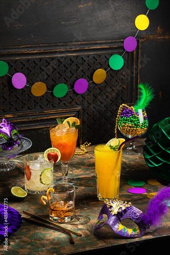 Fényképezés Alcoholic cocktails, Mardi Gras decoration on dark background