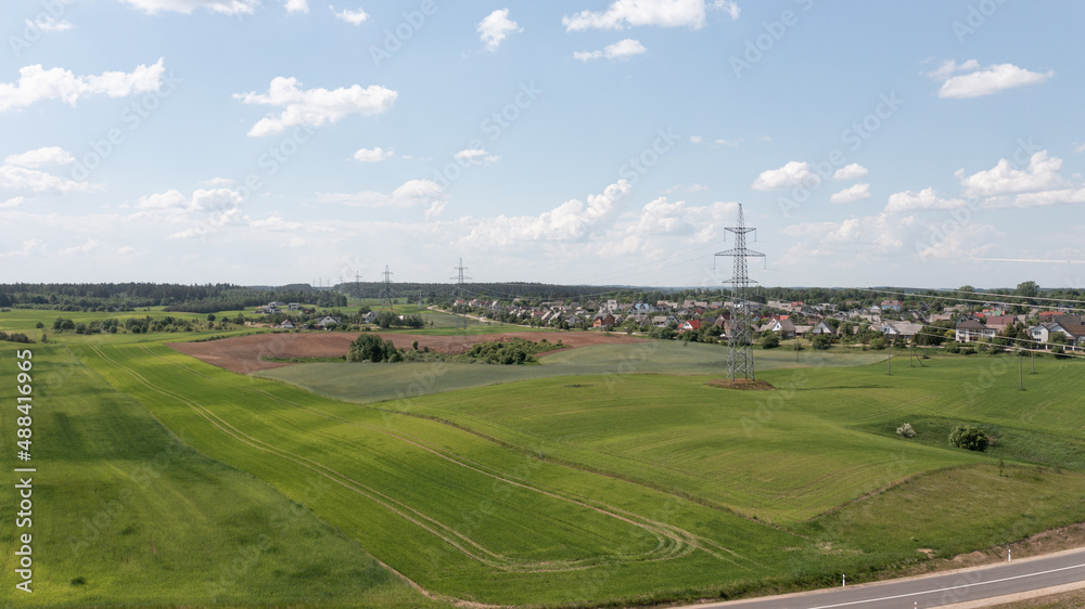 Aerial View of High Voltage Electricity Tower on Green Field
