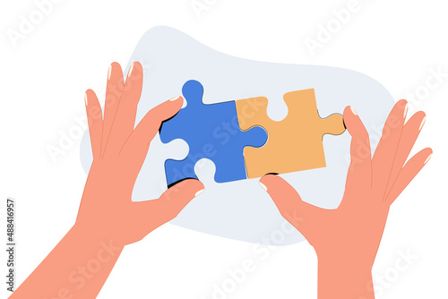 Hands assembling together jigsaw puzzle pieces. Business and corporate communication between coworkers, manager and team