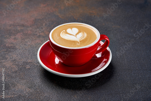 Red cup with coffee on a black background