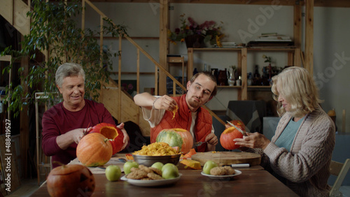 A united family prepares pumpkins for Halloween party