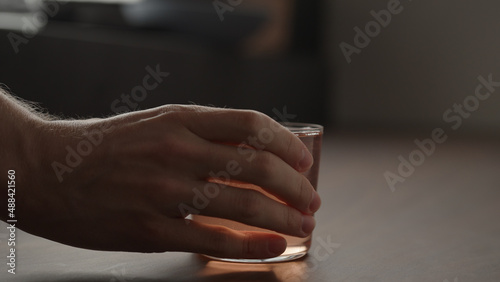 man hand take rhubarb drink in tumbler glass with copy space