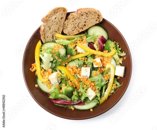 Plate of delicious salad with lentils, vegetables and bread isolated on white, top view