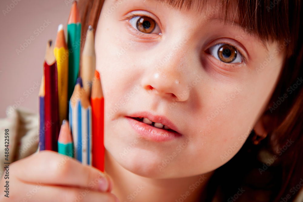 The way to success is work and study. Close up portrait of young beautiful girl with pencils learning to paint. Selective focus. Horizontal image. The way to success is work and study. Close up portrait of young beautiful girl with pencils learning to paint. Selective focus. Horizontal image.