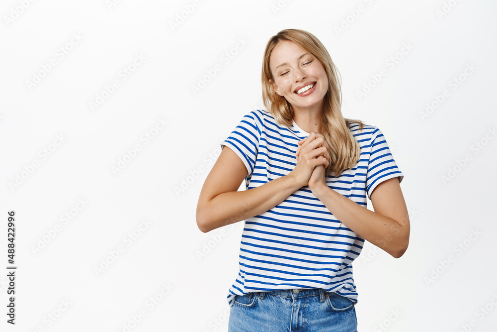 Cute young woman, 25 years old, daydreaming and smiling, gazing with affection and love, tender feelings, posing passionate against white background Cute young woman, 25 years old, daydreaming and smiling, gazing with affection and love, tender feelings, posing passionate against white background