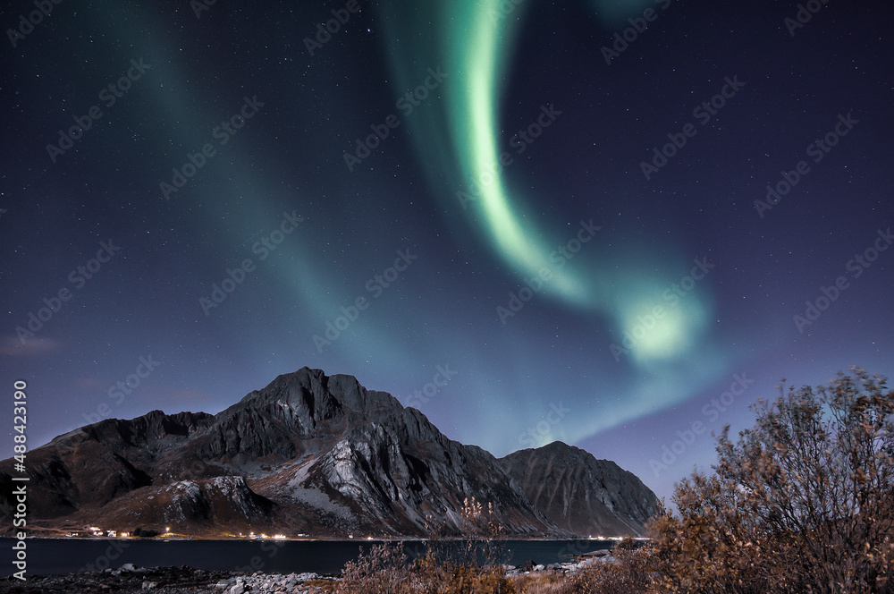 Aurora Borealis on sky in Flakstad island, Lofoten archipelago