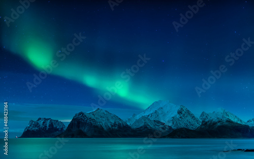 Aurora Borealis on sky in Flakstad island, Lofoten archipelago