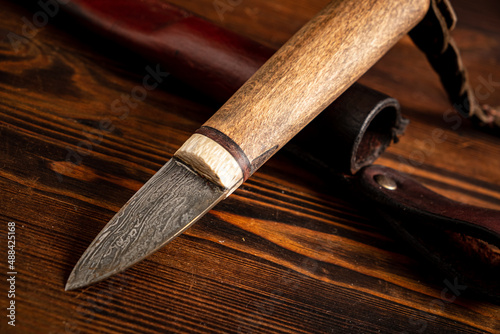 Knife on a wooden background