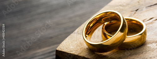 Divorce and separation concept. Two golden wedding rings, judge gavel.