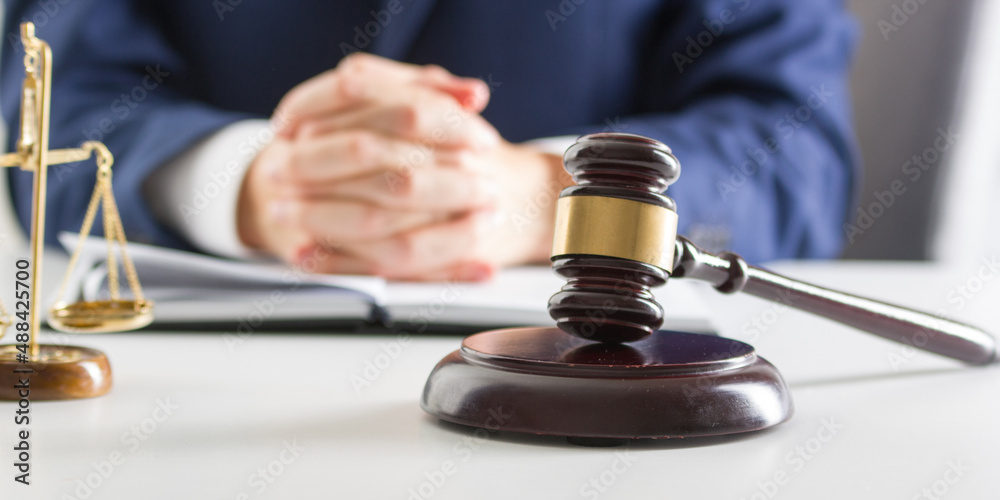 Lawyer working with contract papers and wooden gavel on tabel in courtroom. justice and law ,attorney, court judge concept. Lawyer working with contract papers and wooden gavel on tabel in courtroom. justice and law ,attorney, court judge concept.
