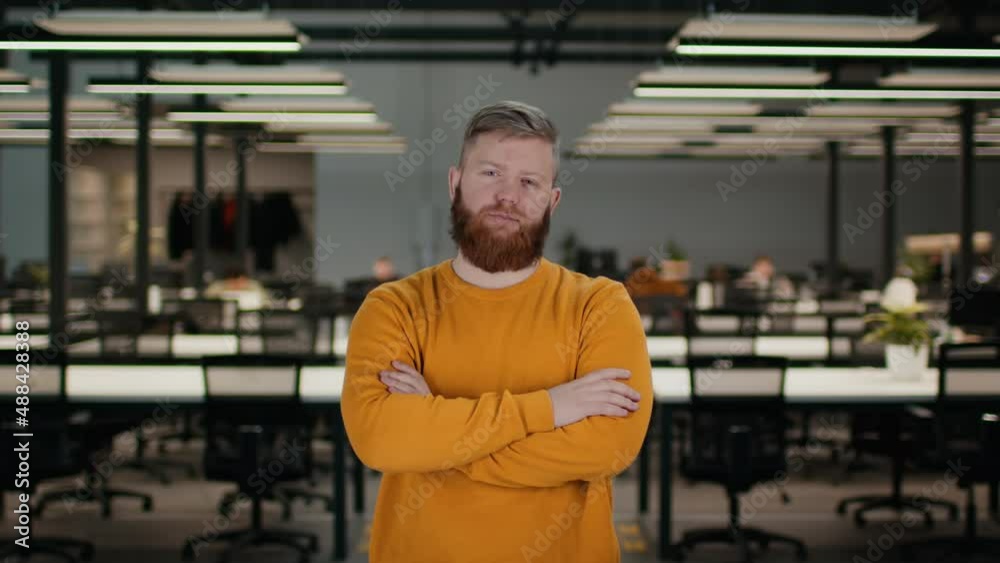 Confident Male Entrepreneur Standing In Modern Office Indoors