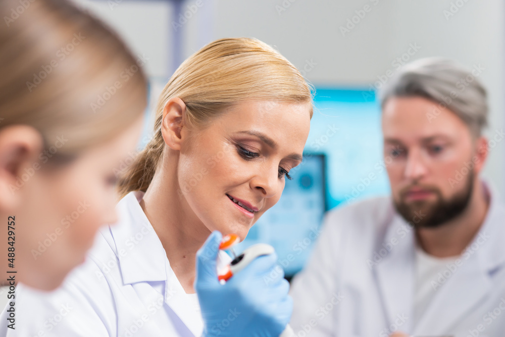 Professional team of scientists is working on a vaccine in a modern scientific research laboratory. Genetic engineer workplace. Future technology and science. Professional team of scientists is working on a vaccine in a modern scientific research laboratory. Genetic engineer workplace. Future technology and science.