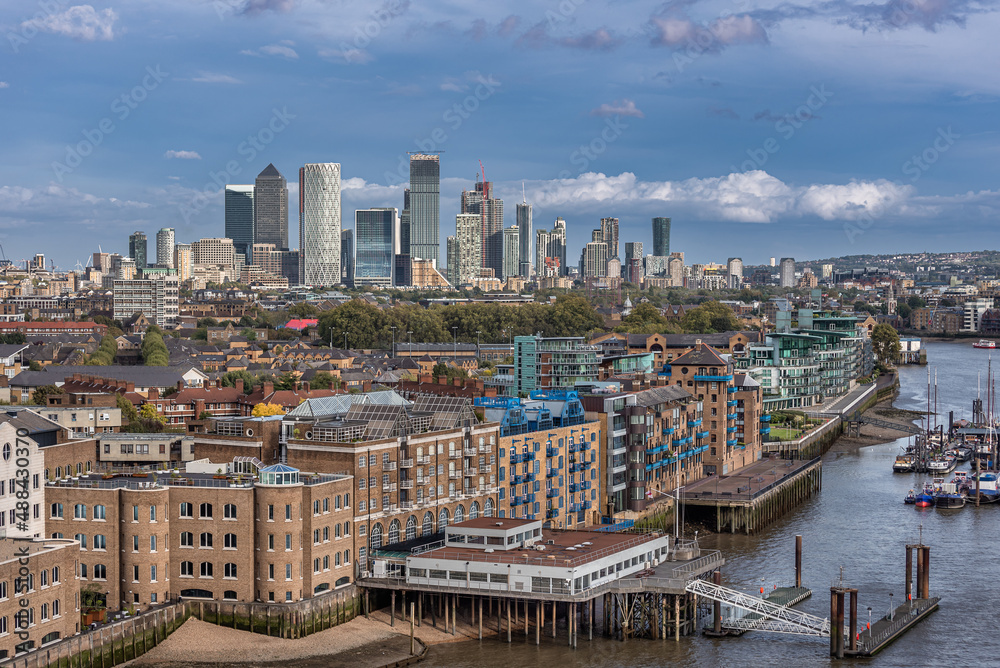 London's St Katharine's district with the Thames River and the skyscrapers of the Docklands in the background. London's St Katharine's district with the Thames River and the skyscrapers of the Docklands in the background.